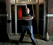 bouncer standing at bar entrance